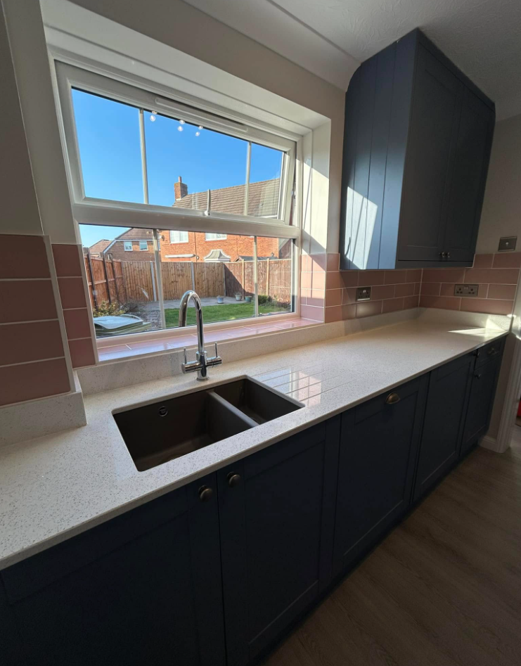 Navy shaker kitchen with blush tiling 3