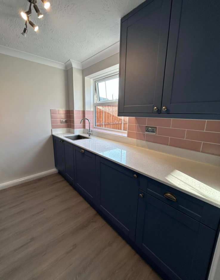 Navy shaker kitchen with blush tiling 2